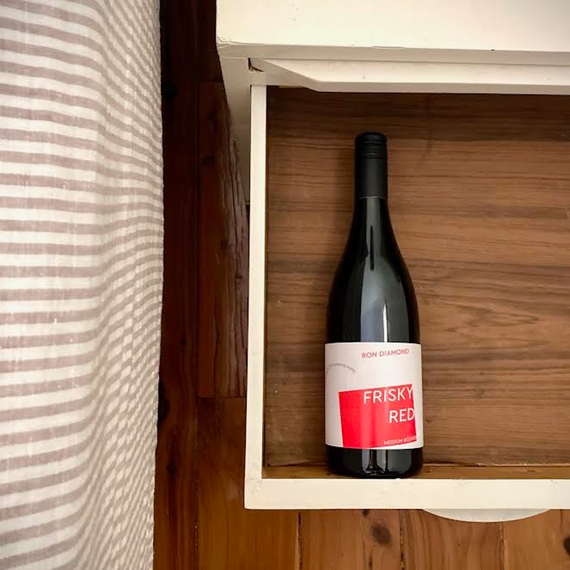 Wine bottle laying down in bedside table drawer